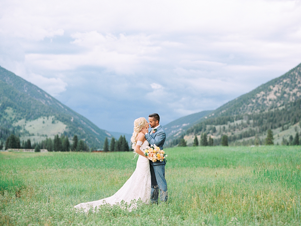 320 Ranch Wedding Bride and Groom in front of mountain backdrop